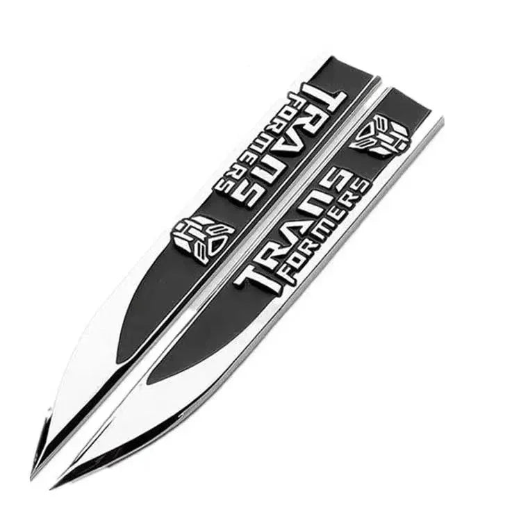 Paire de baguettes argentées avec logo et inscription noire Transformers, style moderne – Transformers.