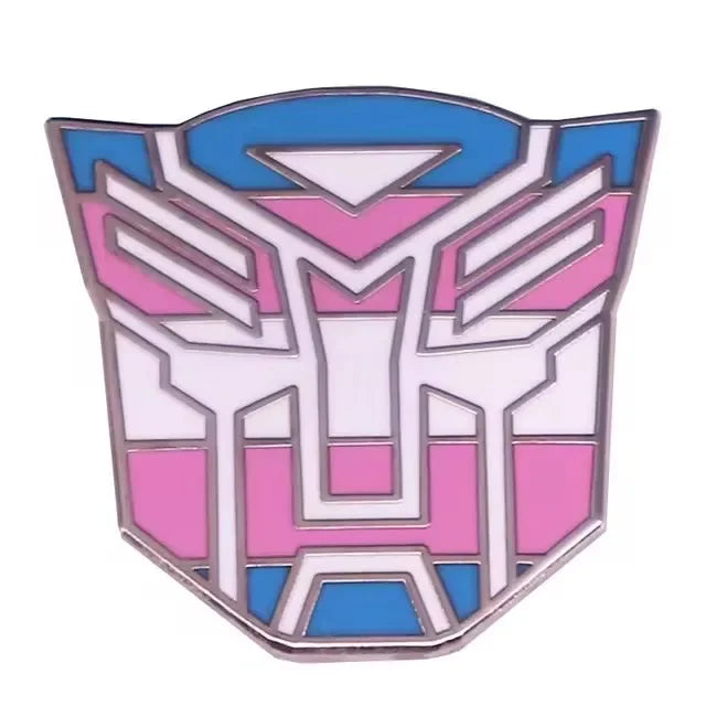 Pin badge Autobot, visage stylisé bleu, rose et blanc, couleurs transgenre – Transformers.