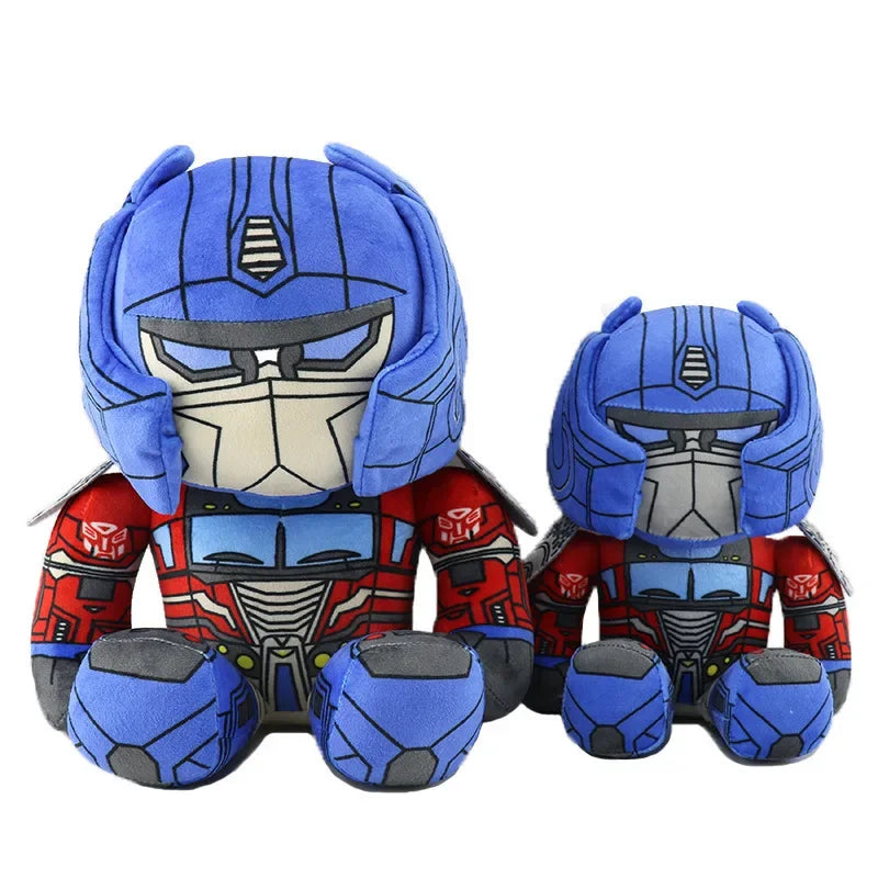 Deux peluches Optimus Prime assises, costume bleu et rouge détaillé sur fond blanc – Transformers.