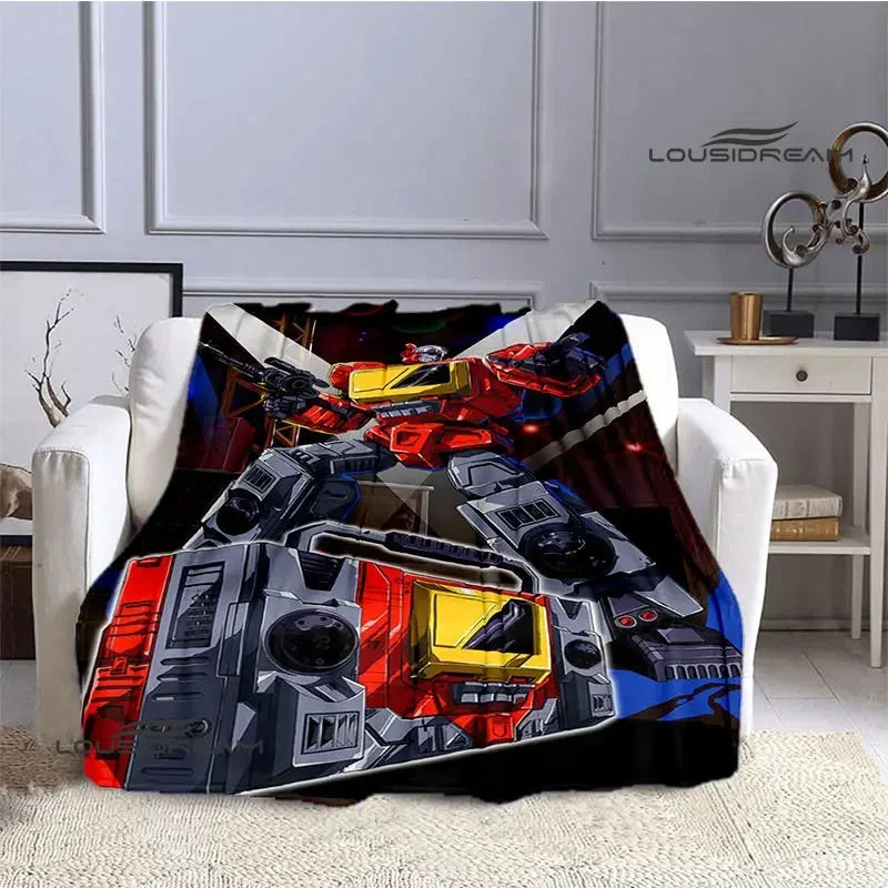 Plaid coloré avec robot Transformers rouge et jaune, motif dynamique sur fauteuil blanc – Transformers.