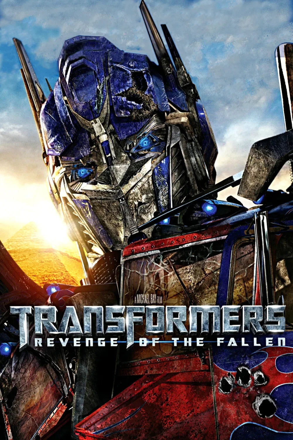 Affiche du film Transformers Revenge of the Fallen avec un robot bleu métallique et pyramide en fond – Transformers.