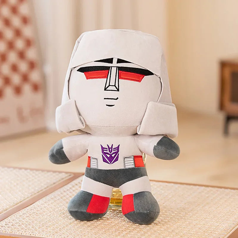Peluche Megatron grise debout, yeux rouges et logo Decepticon sur la poitrine – Transformers.
