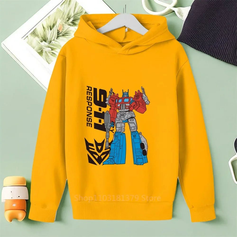 Sweat à capuche jaune avec robot Optimus Prime debout, décor stylisé, logo Autobots – Transformers.