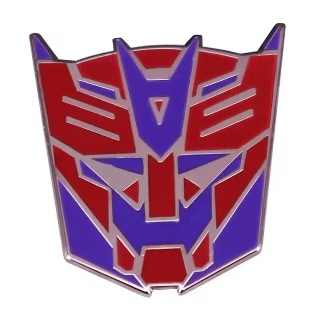 Badge logo Autobot en métal rouge et violet sur fond blanc, style futuriste – Transformers.