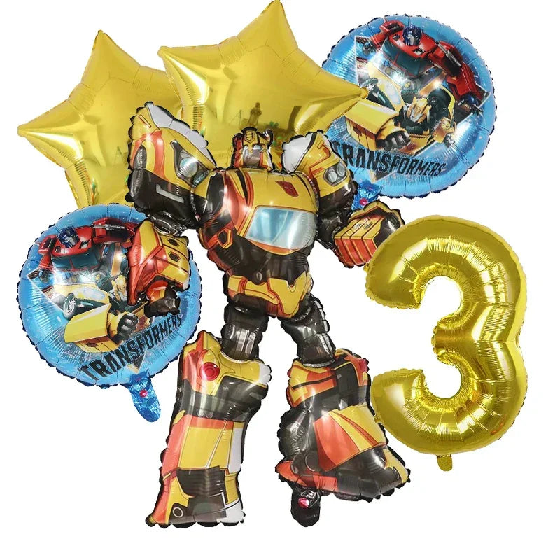 Bouquet de ballons Transformers incluant un robot jaune, deux étoiles dorées, deux ballons ronds et un chiffre 3 doré – Transformers.