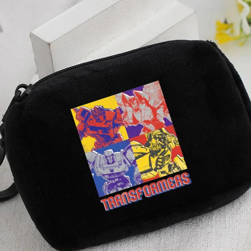 Trousse noire avec design coloré de robots stylisés et logo Transformers – Transformers.