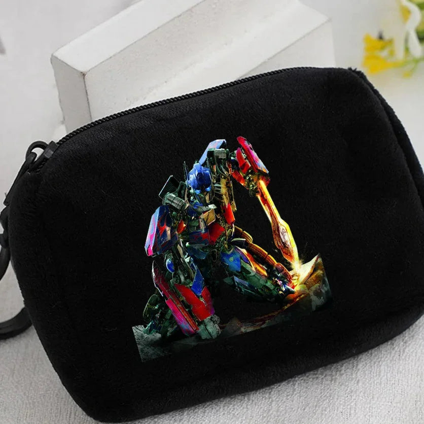 Trousse noire avec motif du robot Optimus Prime agenouillé, style coloré et dynamique – Transformers.