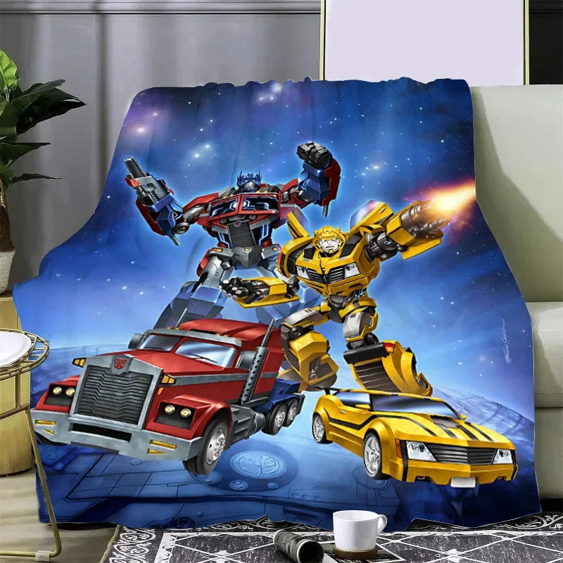 Plaid avec Optimus Prime et Bumblebee en pose dynamique sur fond spatial bleu – Transformers.