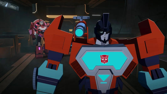 Robot rouge et bleu, posture confiante en avant-plan, décor futuriste sombre – Transformers.
