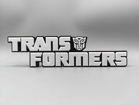 Plaque Transformers Logo Argenté Monochrome — Décoration Bureau Édition Métallisée